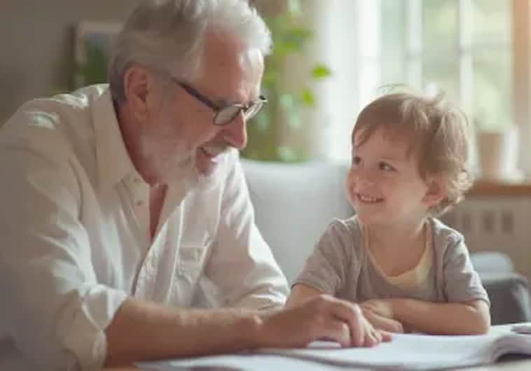 grandpa sitting at a table with his young grandchild