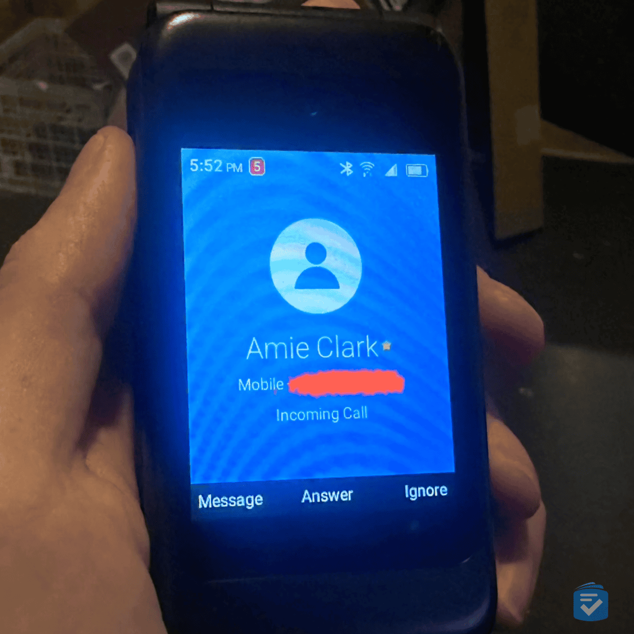 The phone's large external screen made it easy to see who was calling before answering (number redacted).